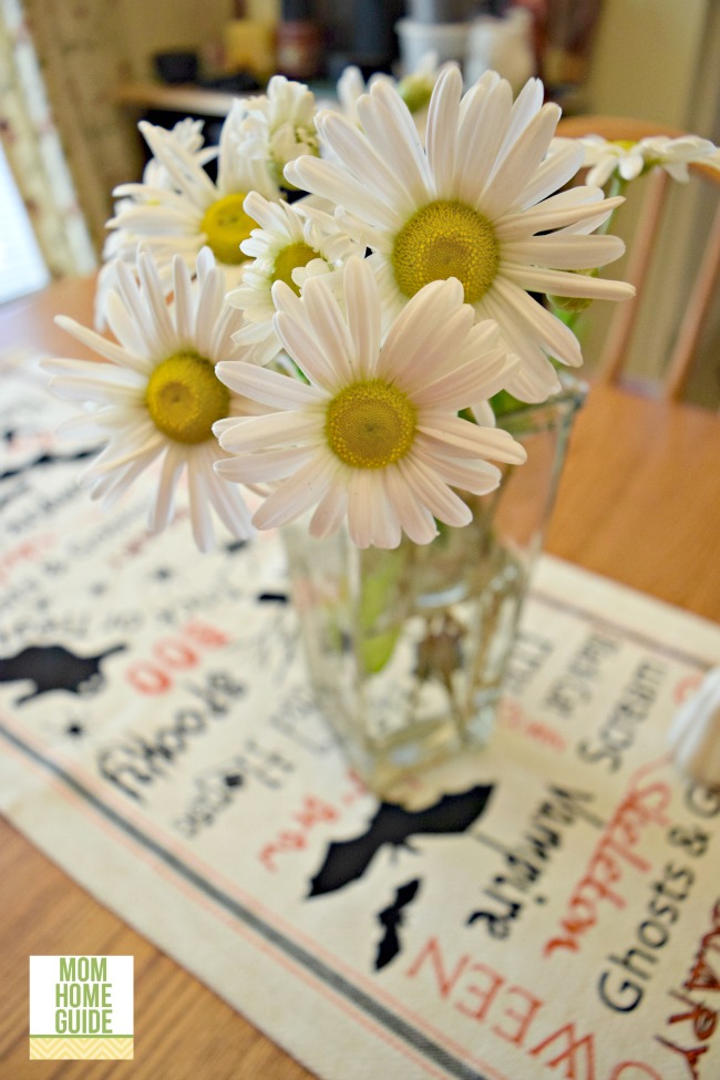 Sweet daisy like mums in a vase on a farmhouse-style kitchen table