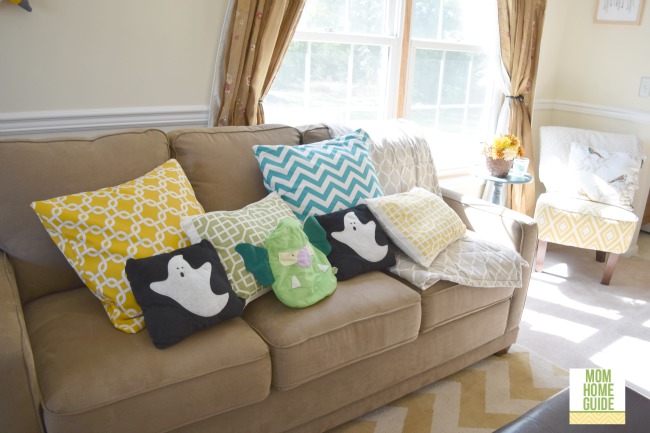Love the Halloween throw pillows on this brightly decorated love seat!