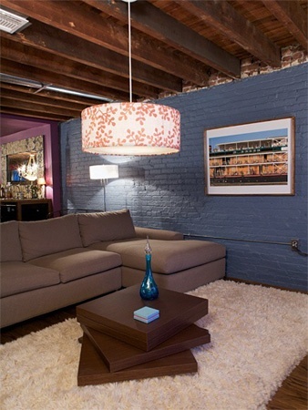 Unfinished basement with painted blue walls and laminate floor