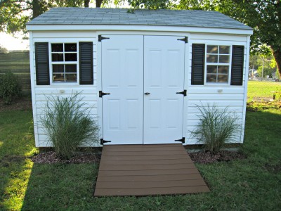 white storage shed, black shutters