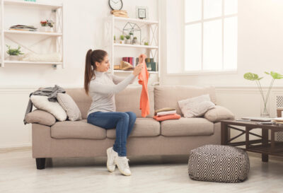 woman folding laundry in living room
