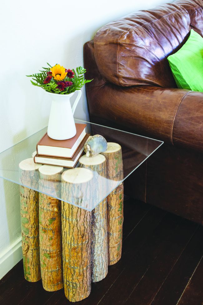 a side table can be made out of tree branches with a glass or plexiglass top