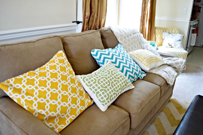 brown living room sofa with bright pillows