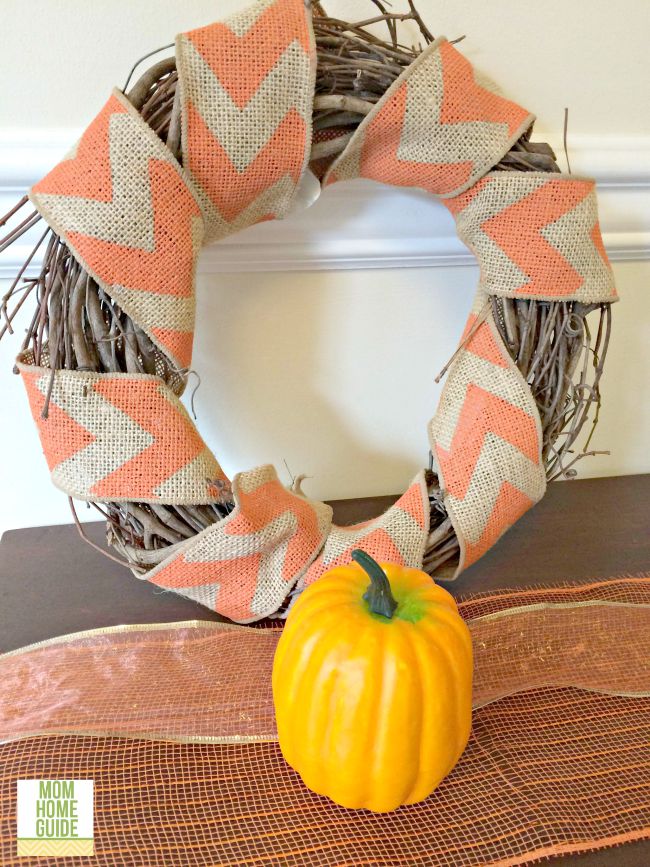 I love how this pumpkin and autumn chevron grapevine wreath looks on this walnut console table!