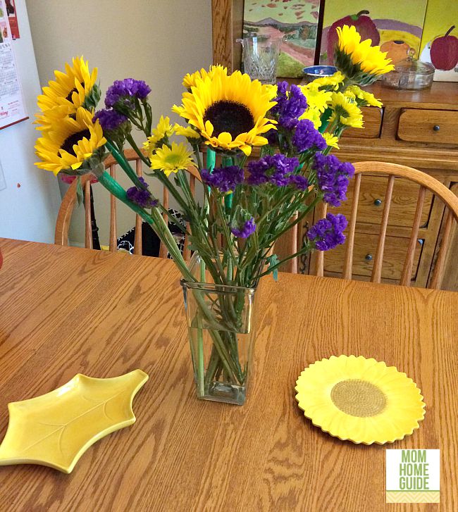 A beautiful oak farmhouse-style table decorated for fall