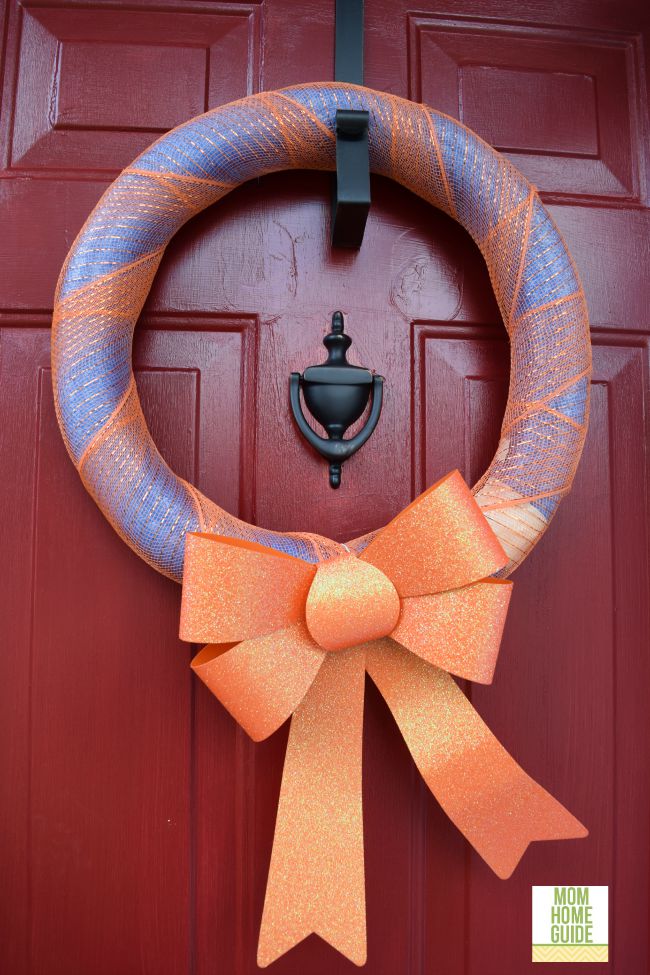 For fall, I created an easy fall wreath by taping a pool noodle together and wrapping it with orange ribbon. I then added a large dollar store bow!