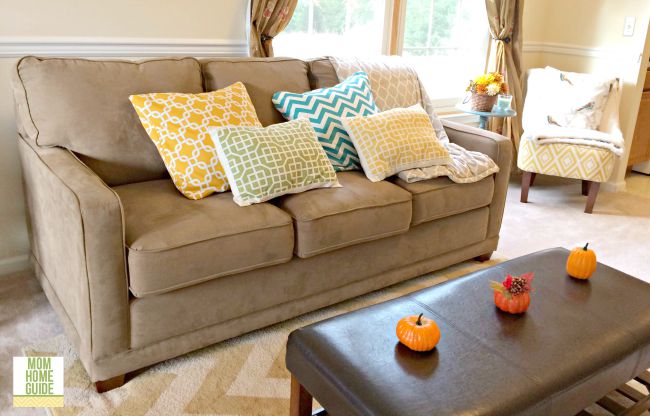 A bright and sunny living room decorated for fall