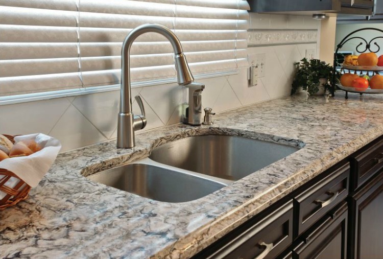 I love the undermount stainless steel sink in this remodeled kitchen by Kitchen Magic!