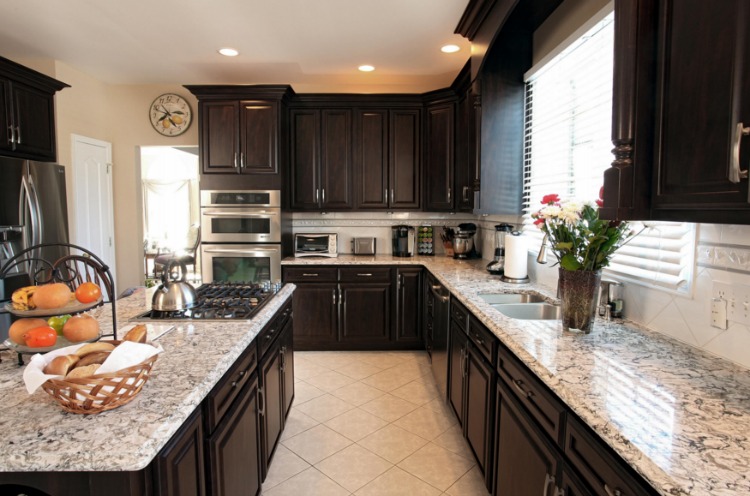 Remodeled kitchen with refaced dark cabinets and Cambria Quartz countertops