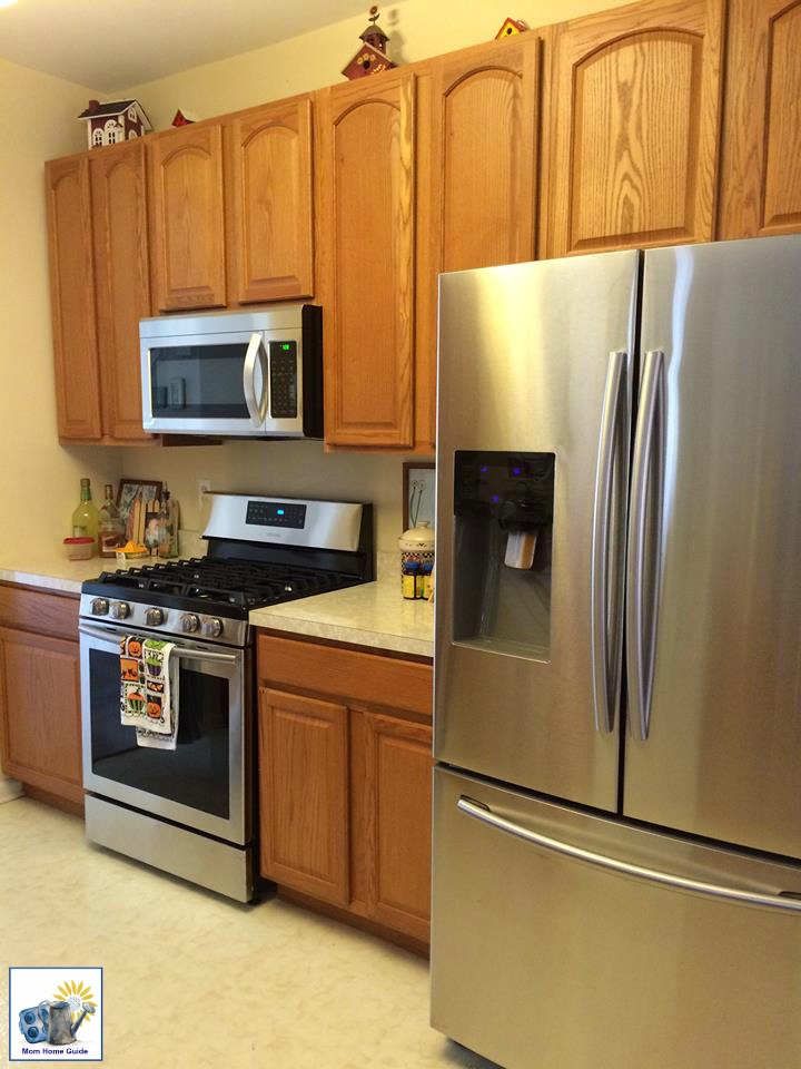 oak kitchen with stainless-steel appliances