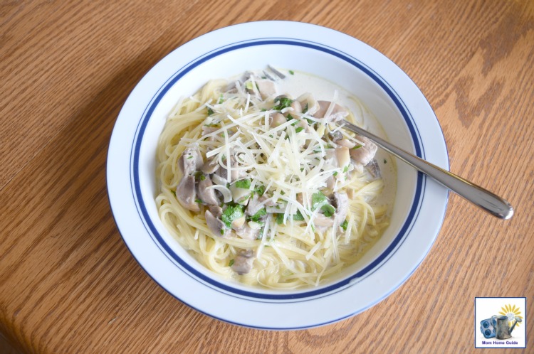 pasta with a creamy leak and mushroom sauce, topped with shaved parmesan cheese