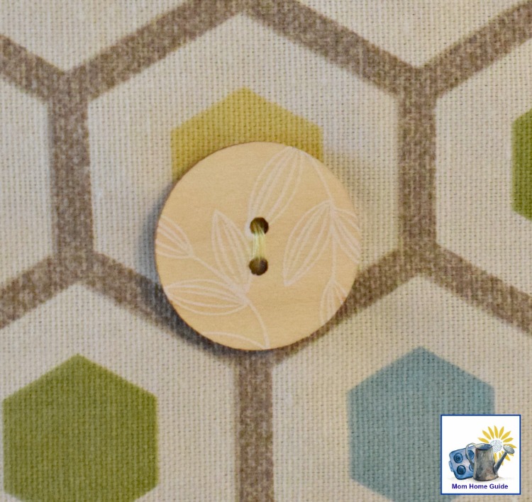 leaf accented button on geometric fabric 