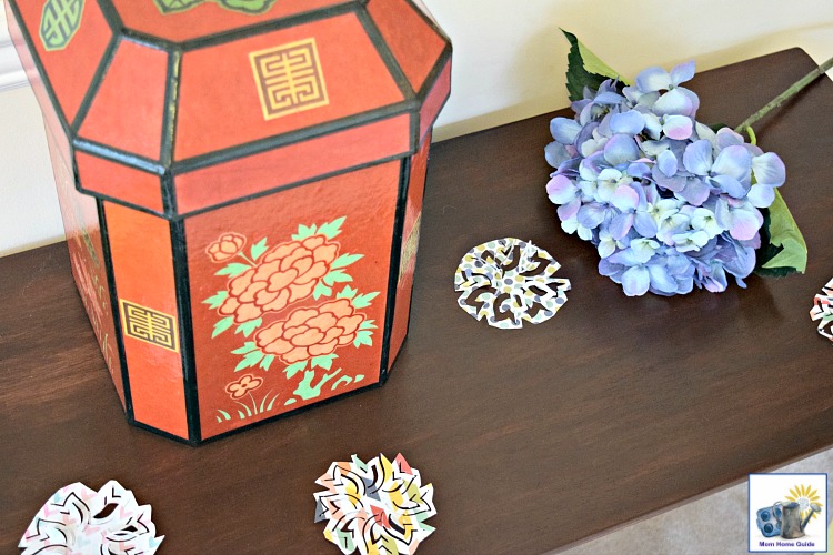 Console table decorated with a beautifully decorated box and scrapbook paper scatters for spring