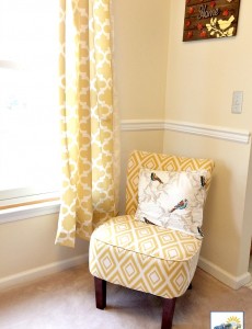 Living room with yellow and white accent chair and curtains