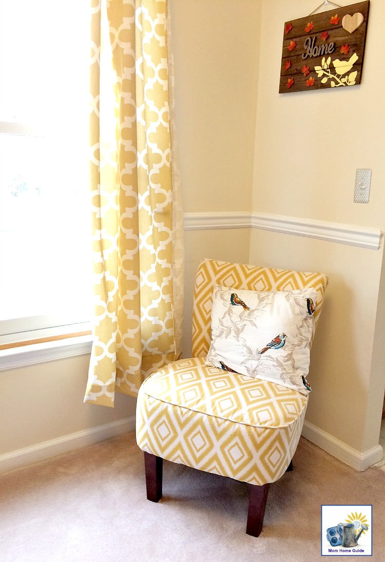 Living room with yellow and white accent chair and curtains