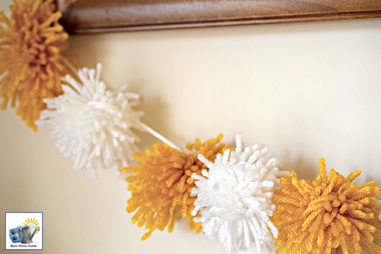 It's easy to make a cute and fun pom pom banner out of yarn