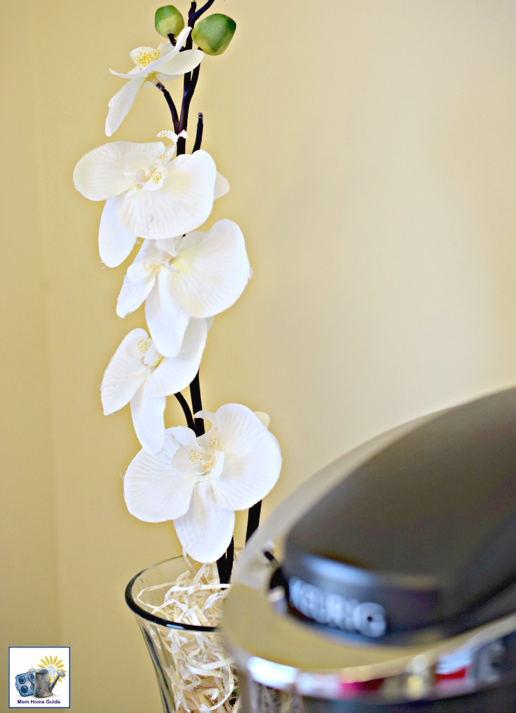 Faux flowers in vase with wood shavings