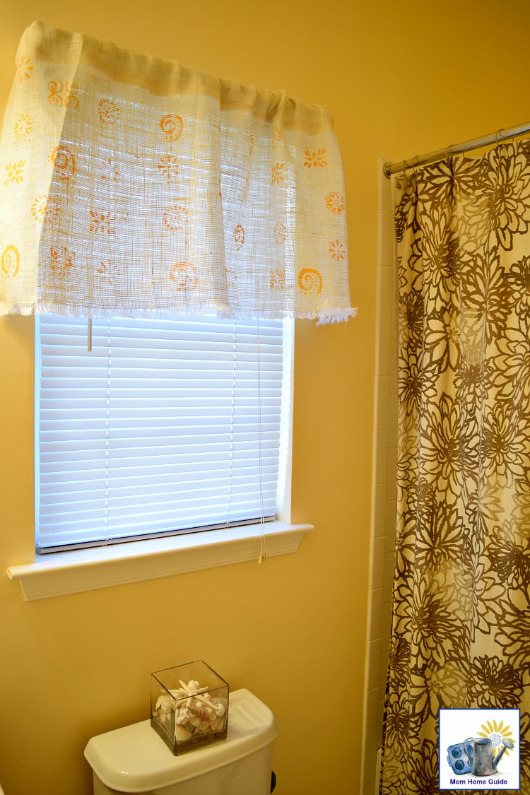 Yellow bathroom with hand stenciled burlap curtain