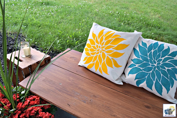 I love this cozy outdoor seating area, with a DIY bench and stenciled pillows