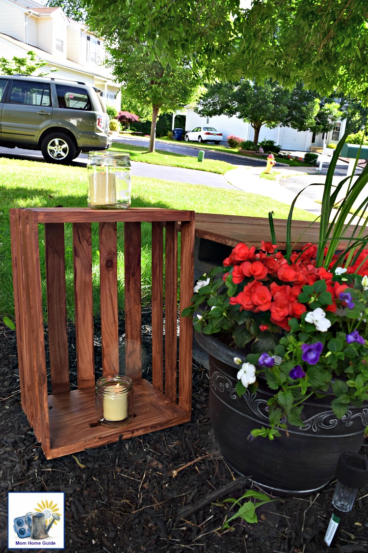 A DIY garden side table made from a stained unfinished wood crate