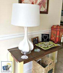 White fluted gourd-shaped lamp on a DIY chalk painted console table in a living room