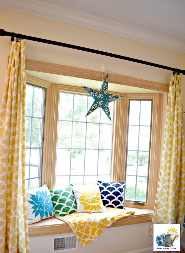 bright and sunny window seat with colorful throw pillows