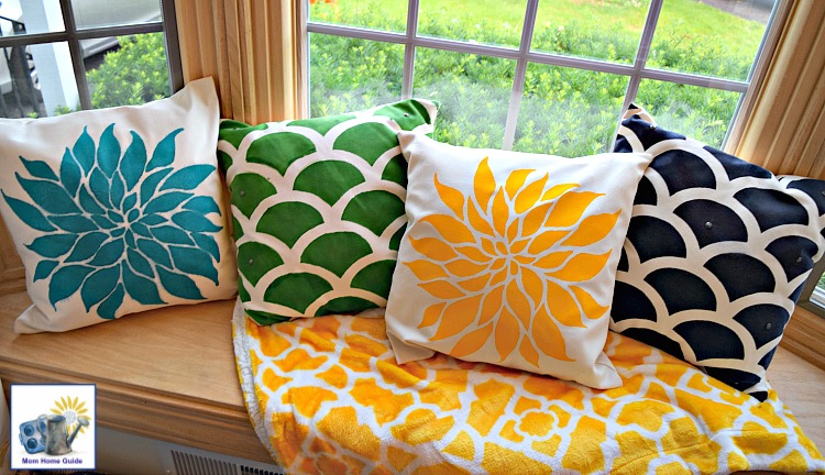 Beautiful window seat with a colorful thrown and stenciled pillows