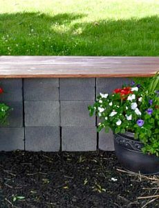 DIY Garden seating area with a wood and cinder block bench and container gardens