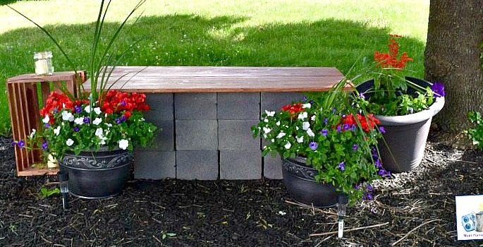DIY Garden seating area with a wood and cinder block bench and container gardens