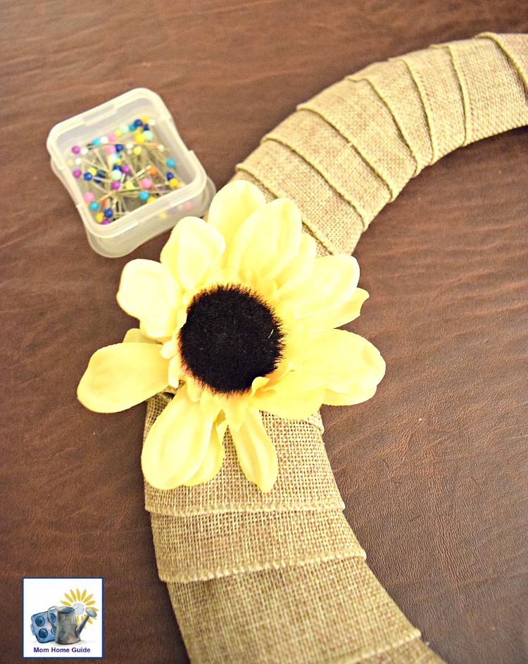pin flowers to burlap wrapped wire wreath form