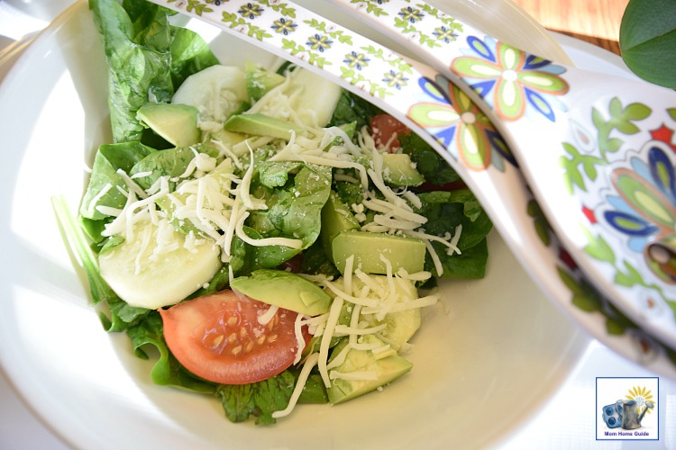 Fresh tomato, spinach and avocado salad with shredded mozzarella cheese