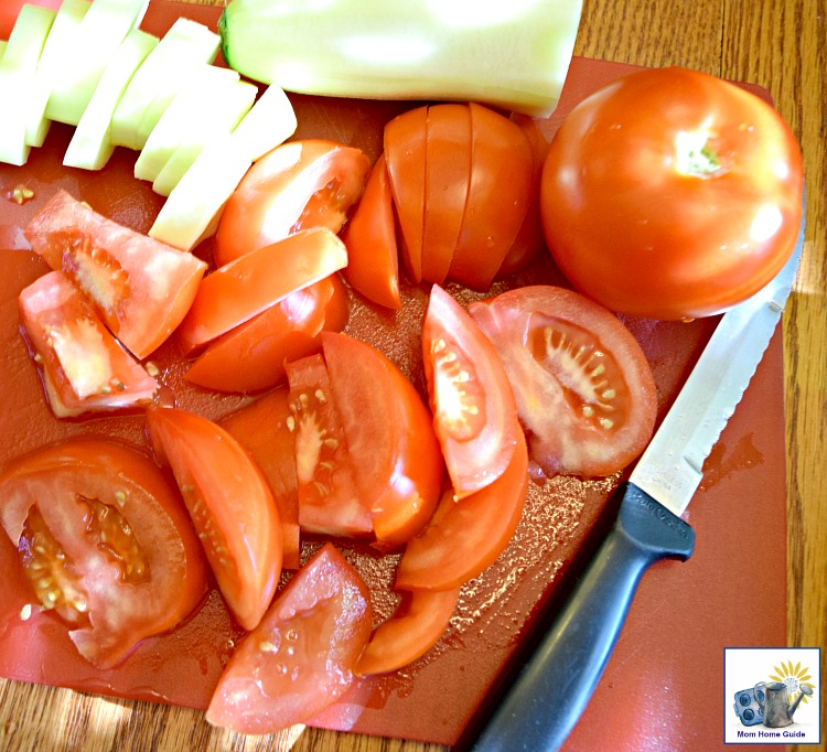 cutting tomatoes on cutting board