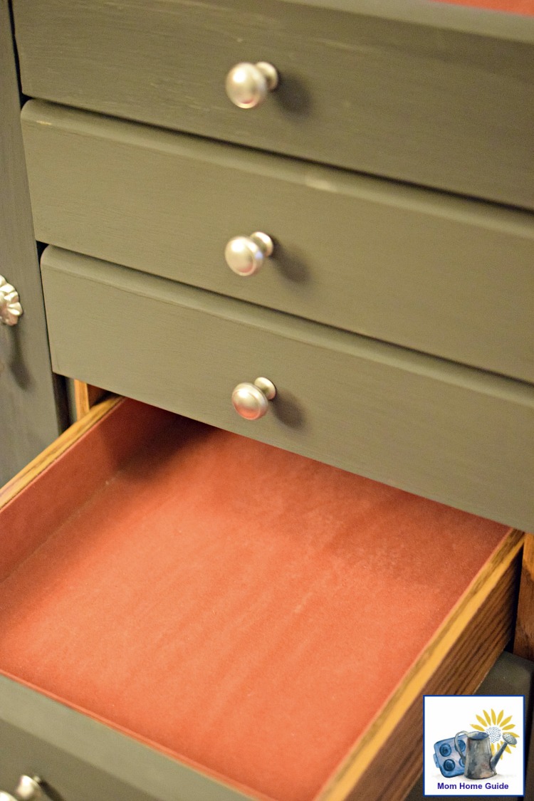 fabric lined drawer of jewelry armoire