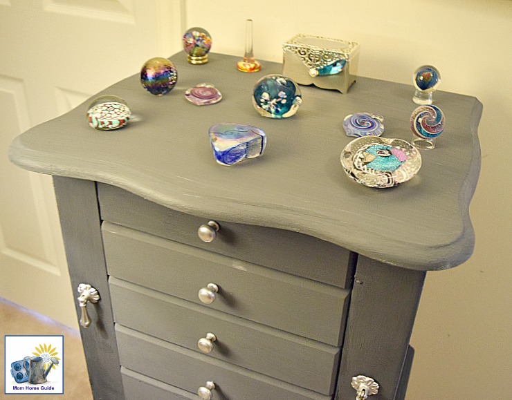 Jewelry armoire decorated with beautiful glass paperweights