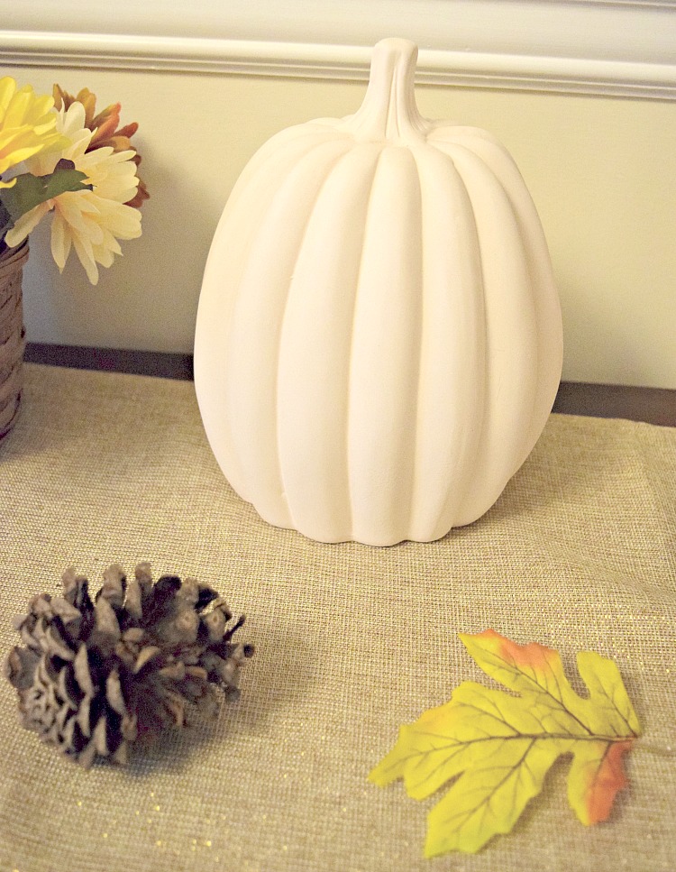 white ceramic pumpkin from Oriental Trading on a console table
