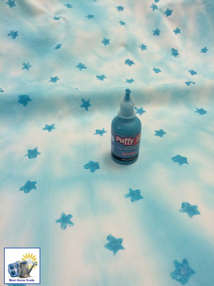 Adding star stamps to blue tie dyed pillowcases