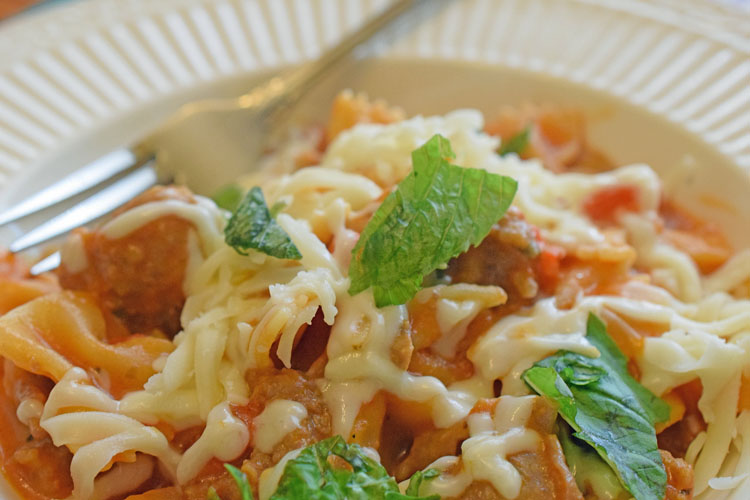 Pasta with cheese, sausage, mushrooms, red peppers and basil