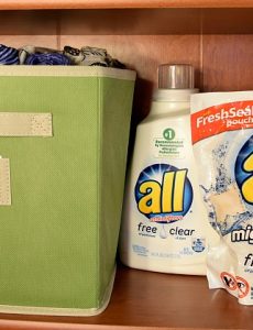 Using, pretty cloth bins, you can create "closet" space in a simple bookcase.