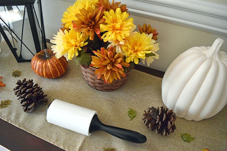 Using a Scotch-Brite™ Lint Roller to clean dust off a table runner