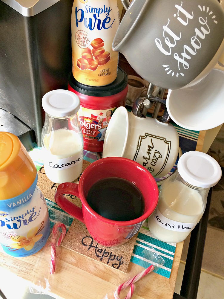 A holiday coffee bar with Christmas mugs and flavored creamers.