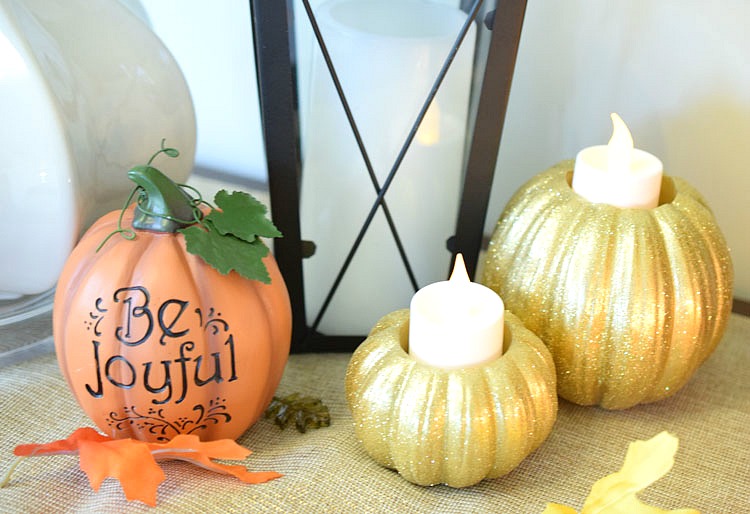 Gold glitter pumpkins on a console table