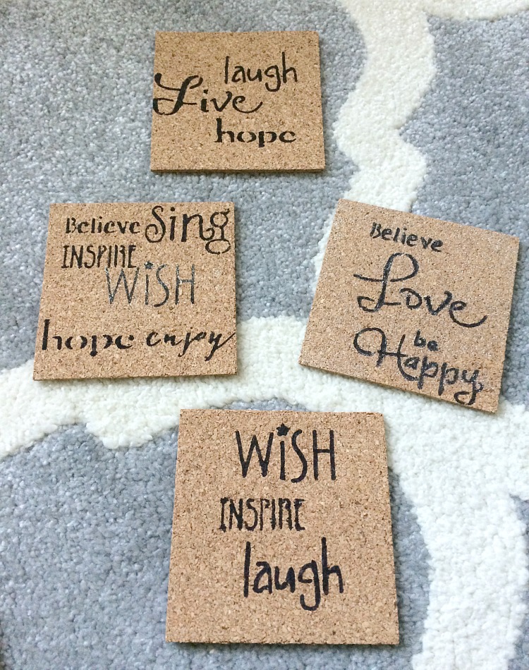 Cork coasters hand-stenciled with a black permanent marker