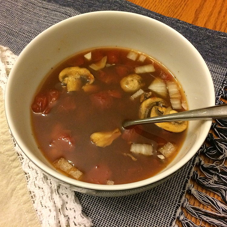 Homemade vegetable soup with diced tomatoes, beans and mushrooms