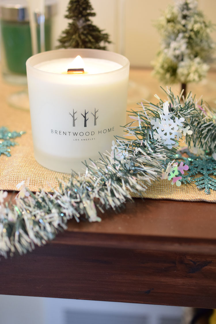 White soy candle on Christmas console table