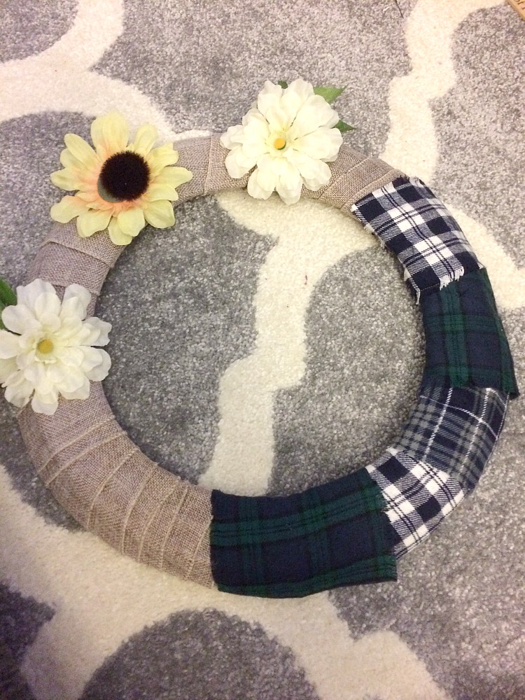 Pin strips of fabric to a burlap wrapped metal wreath form to create an inexpensive and beautiful winter wreath