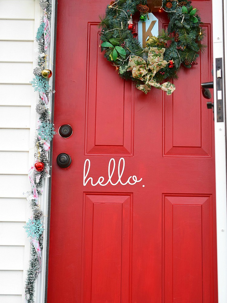 Festive red door decorated for Christmas
