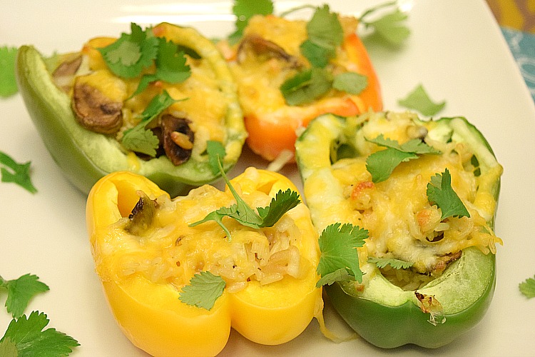 Orange, yellow and green peppers stuffed with rice, mushrooms, onion and garlic