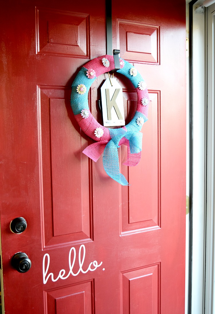Pink and blue pinwheel wreath on a red front door
