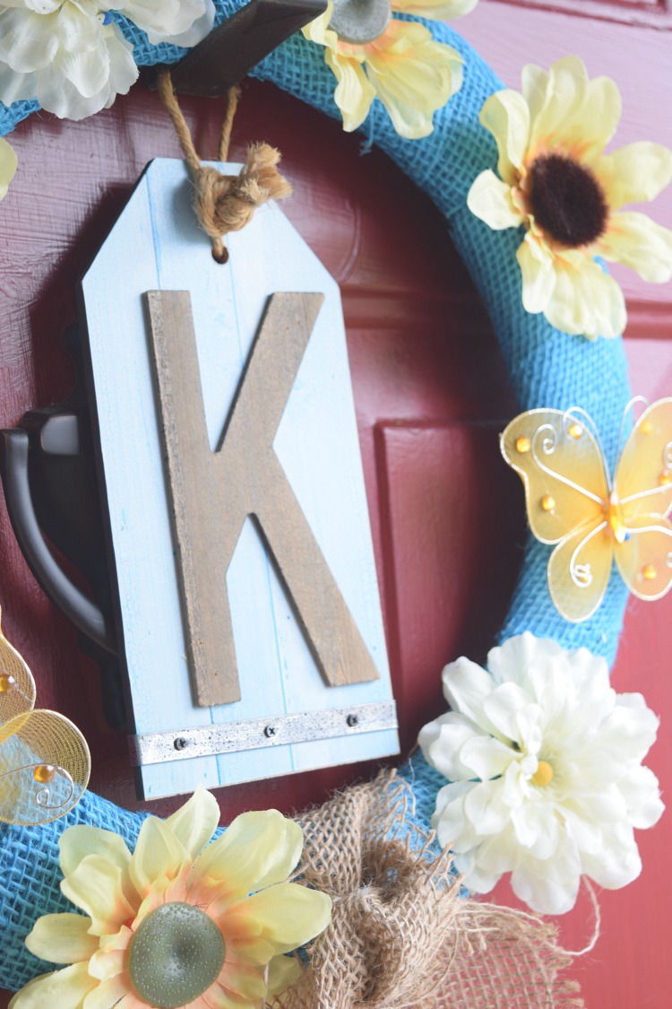 blue and yellow burlap wreath with yellow faux flowers and butterflies