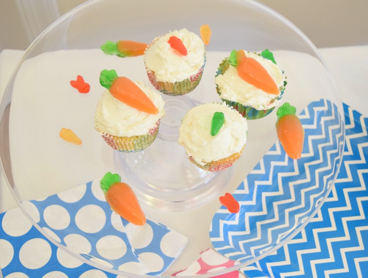 clear cupcake stand with Vanilla buttercream cupcakes decorated with gummy carrots and bunnies from Oriental Trading